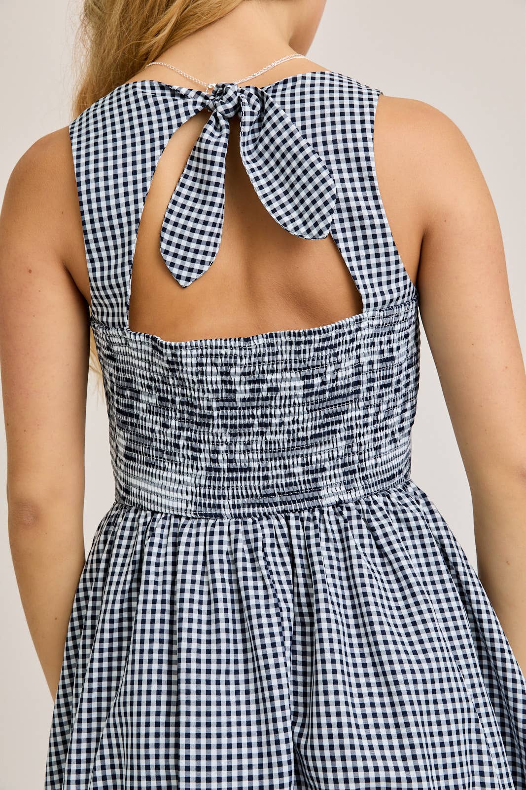 BOAT NECK SLEEVELESS BUBBLE HEM DRESS: NAVY - Rose & Olivia Boutique